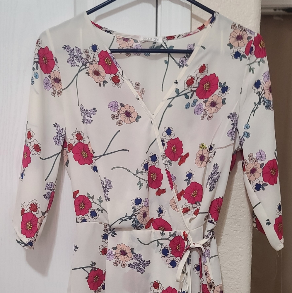 - White blouse with floral pattern, tie on the front of shirt.